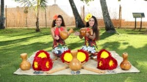 Women showcasing Polynesian activities at Diamond Head Luau