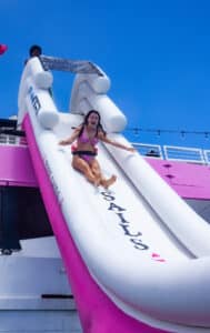 girl on a big water slide on Waikiki Water Adventure tour with Pink Sails Waikiki
